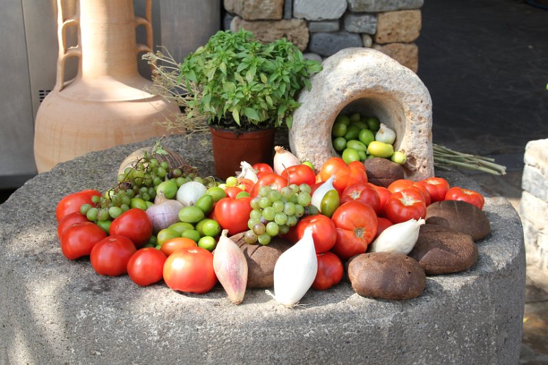 IMG_8384.JPG - It's all in the Presentation...  This caught my eye at the Ferryman Taverna (restaurant).   Very frresh fruits and vegetables arranged on a large milling stone!